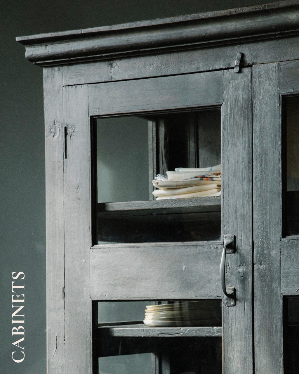 Detail of a black vintage vitrine cabinet.