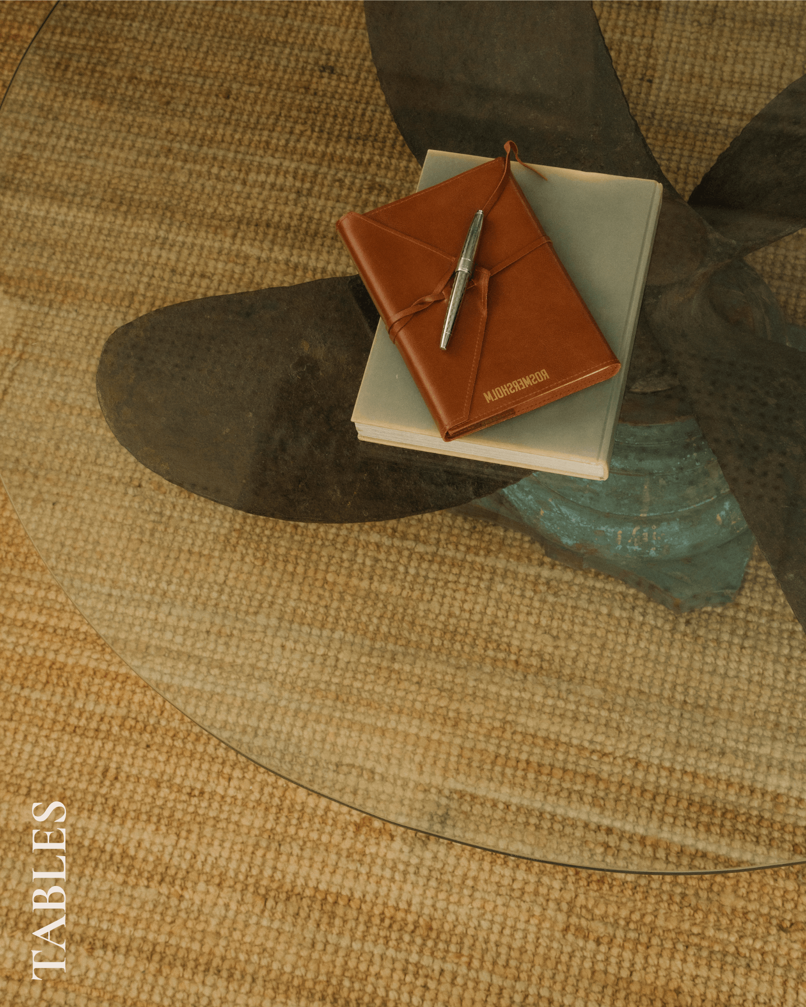 Glass cofee table on a jute rug.