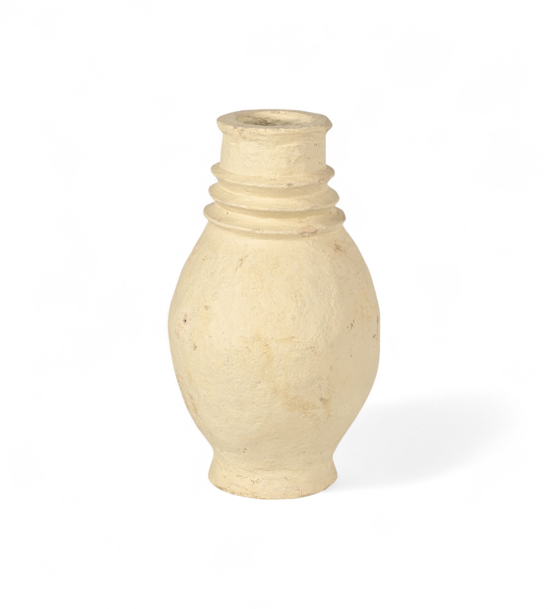 A handcrafted beige papier mache planter with a smooth finish.
