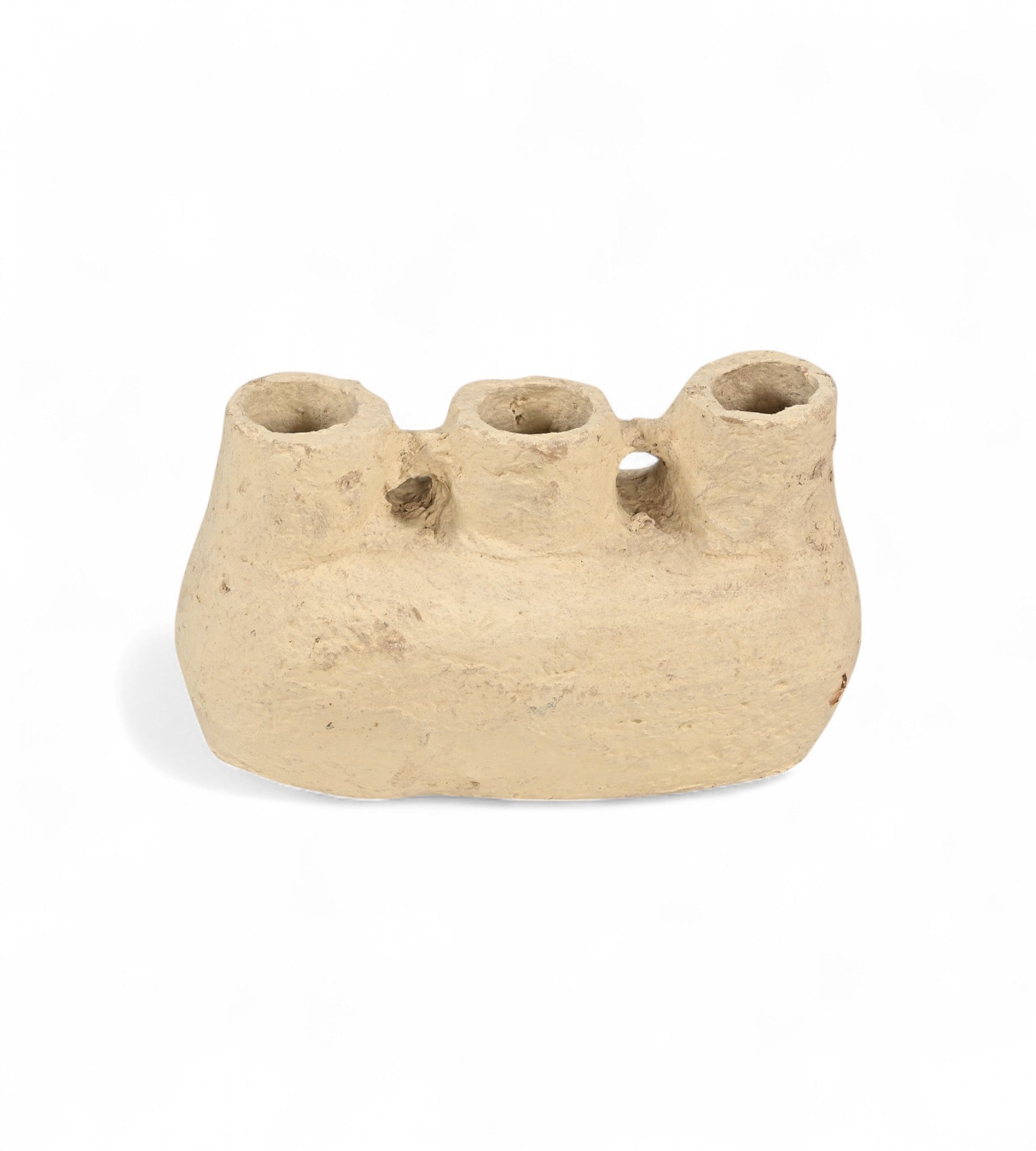 A beige papier mache pot with a sculptural form, featuring multiple openings on the top.