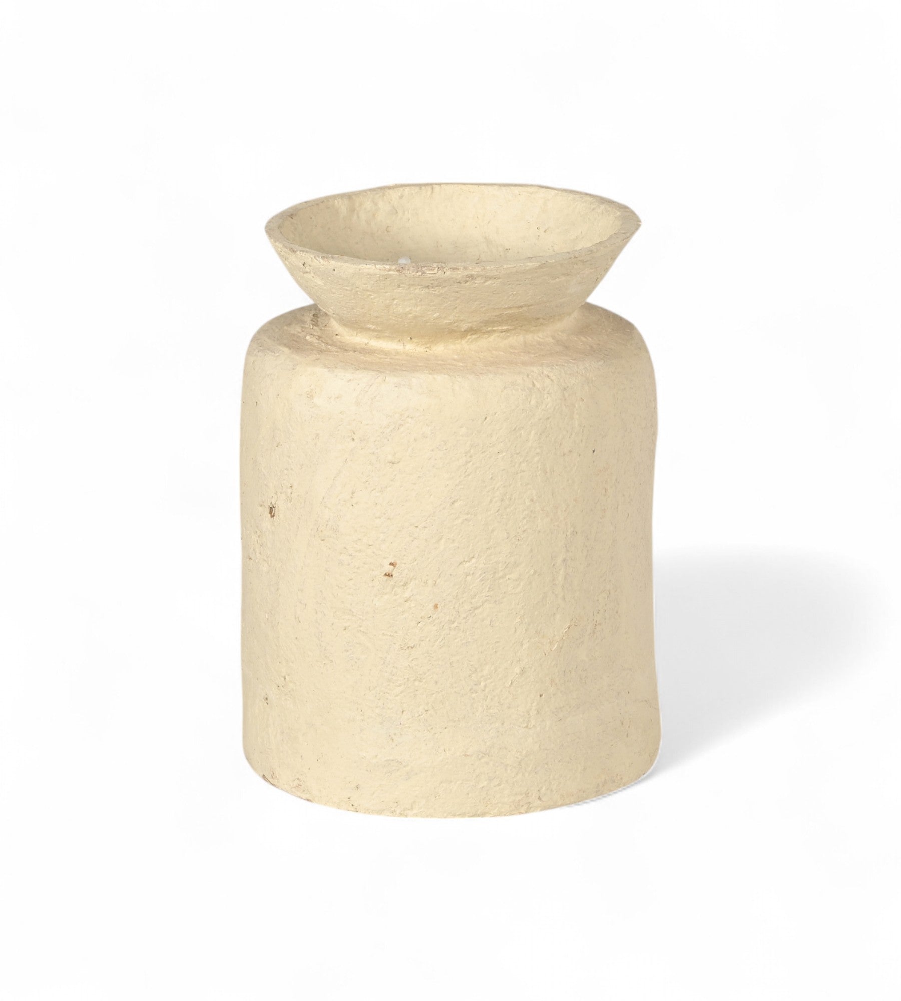 A cylindrical off white papier mache planter with a textured surface.