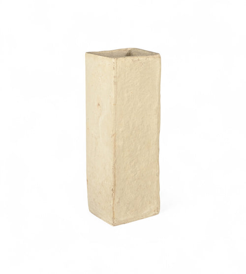 A beige papier mache planter with a minimalist and slender design, hand moulded in India, suitable for holding plants or dried flowers.