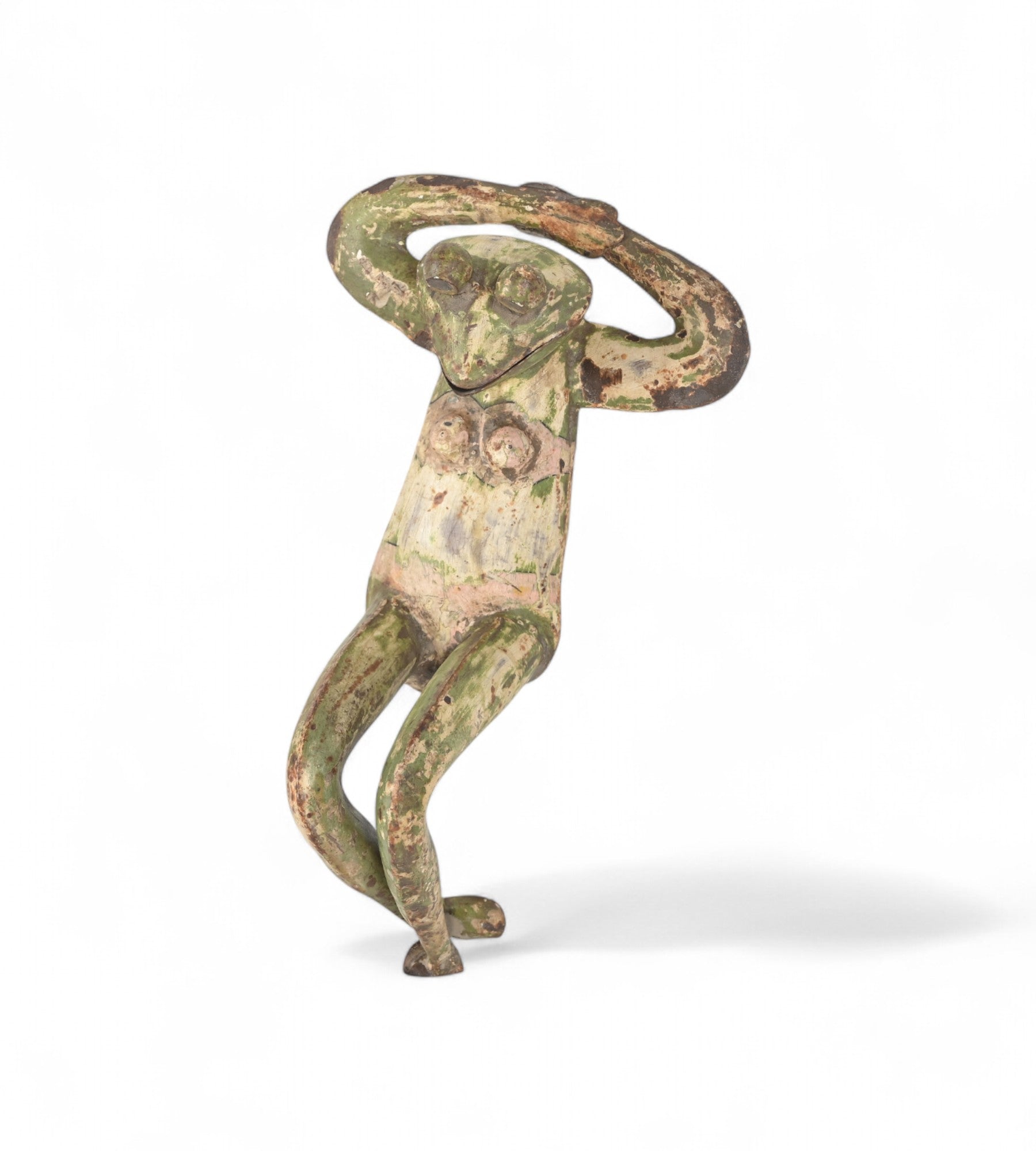 A decorative iron frog with a weathered green patina, crafted in a playful pose.