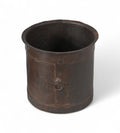 A vintage Indian iron pot with a worn finish, cylindrical shape, and a subtle industrial feel.