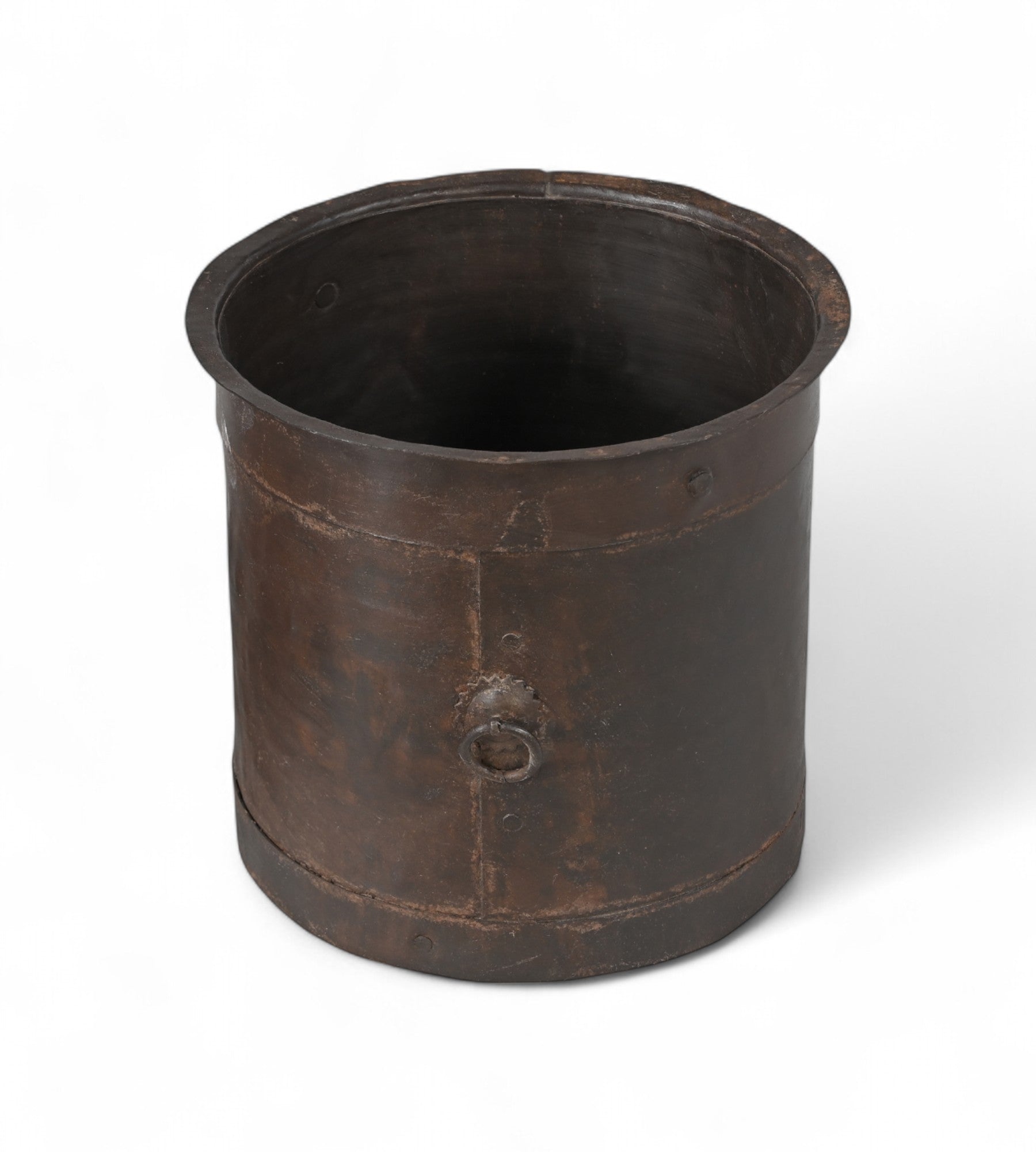 A vintage Indian iron pot with a worn finish, cylindrical shape, and a subtle industrial feel.
