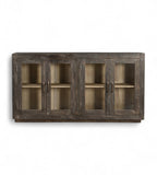 A mango wood sideboard with four glass fronted doors and a black and lime wash finish.