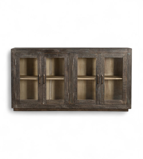 A mango wood sideboard with four glass fronted doors and a black and lime wash finish.