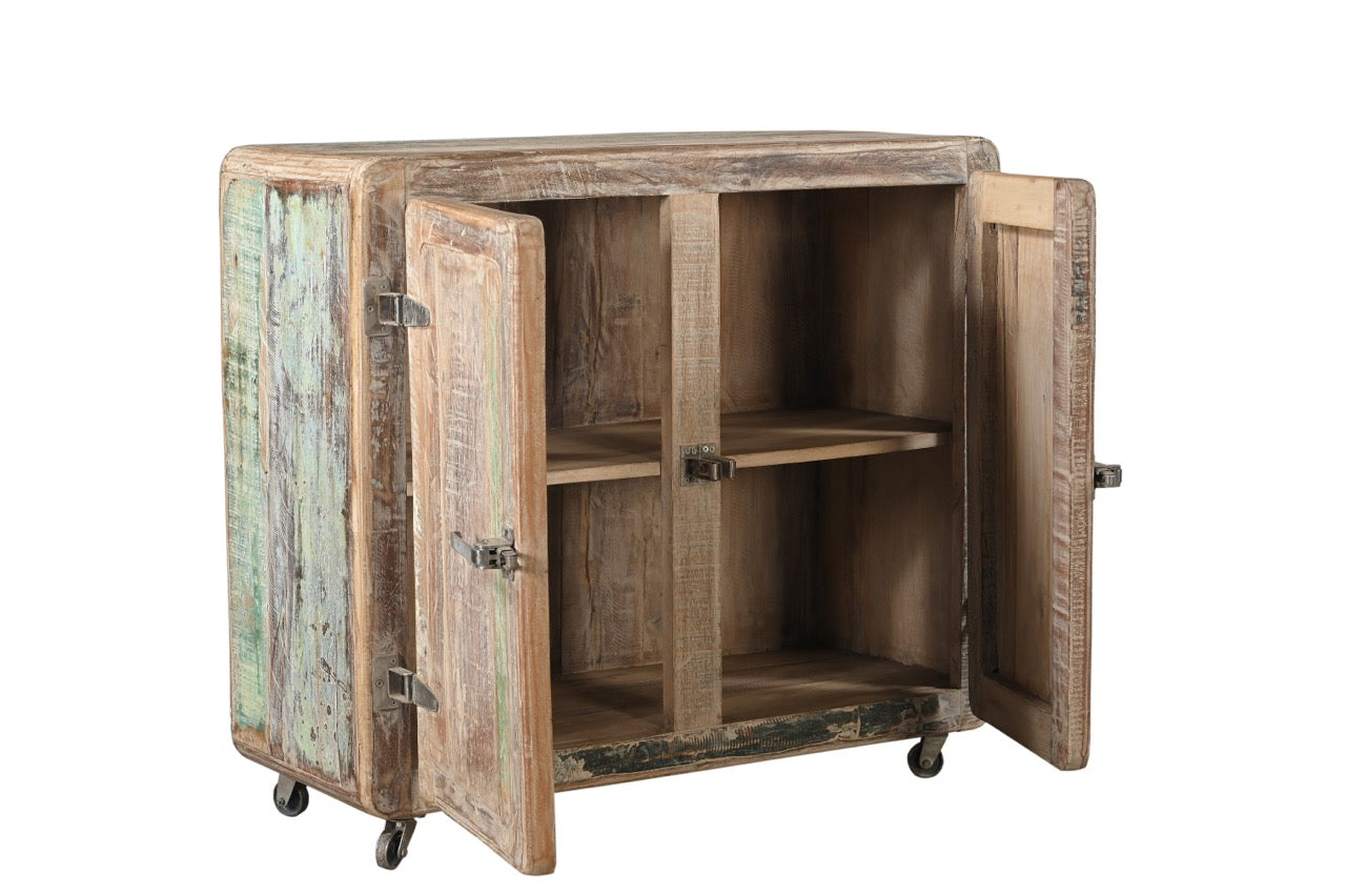 Vintage Indian reclaimed wood side cabinet with iron latches and wheels, featuring a faded multi-coloured patina.
