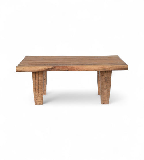 A rectangular natural brown reclaimed wood coffee table with visible wood grain and natural edges.