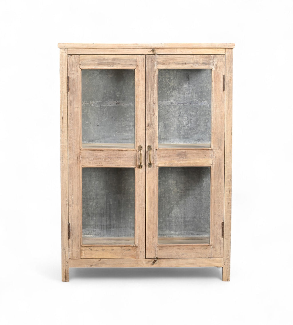 A reclaimed wood display cabinet with glass panel doors and an iron sheet backing.