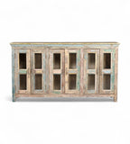 A recycled wood sideboard with glass panels on the doors and a multicolor finish.