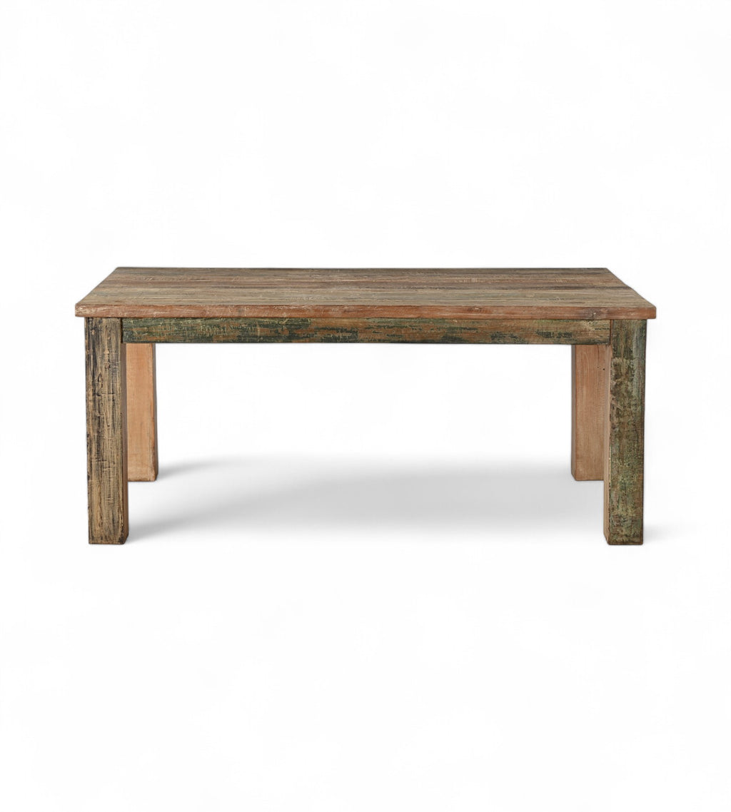 A rectangular kitchen dining table made of reclaimed wood with a rustic patina finish.