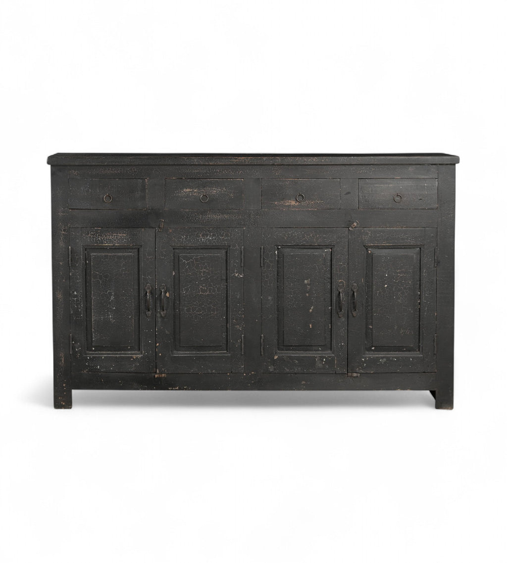 A black, mango wood sideboard with four drawers and a cracked patina finish.