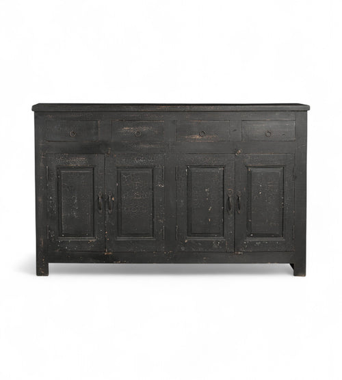 A black, mango wood sideboard with four drawers and a cracked patina finish.
