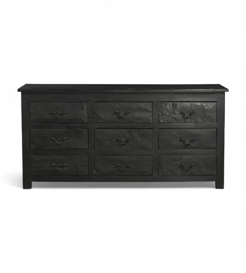 A vintage black teak wood 9-drawer chest of drawers with iron sheets pasted over the front.