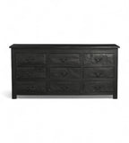 A vintage black teak wood 9-drawer chest of drawers with iron sheets pasted over the front.