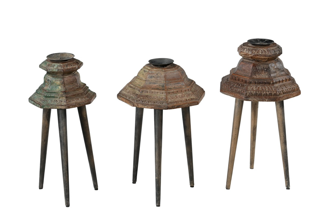 Three decorative candle holders with intricate designs