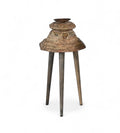 Carved teak candle holders on top of three legs