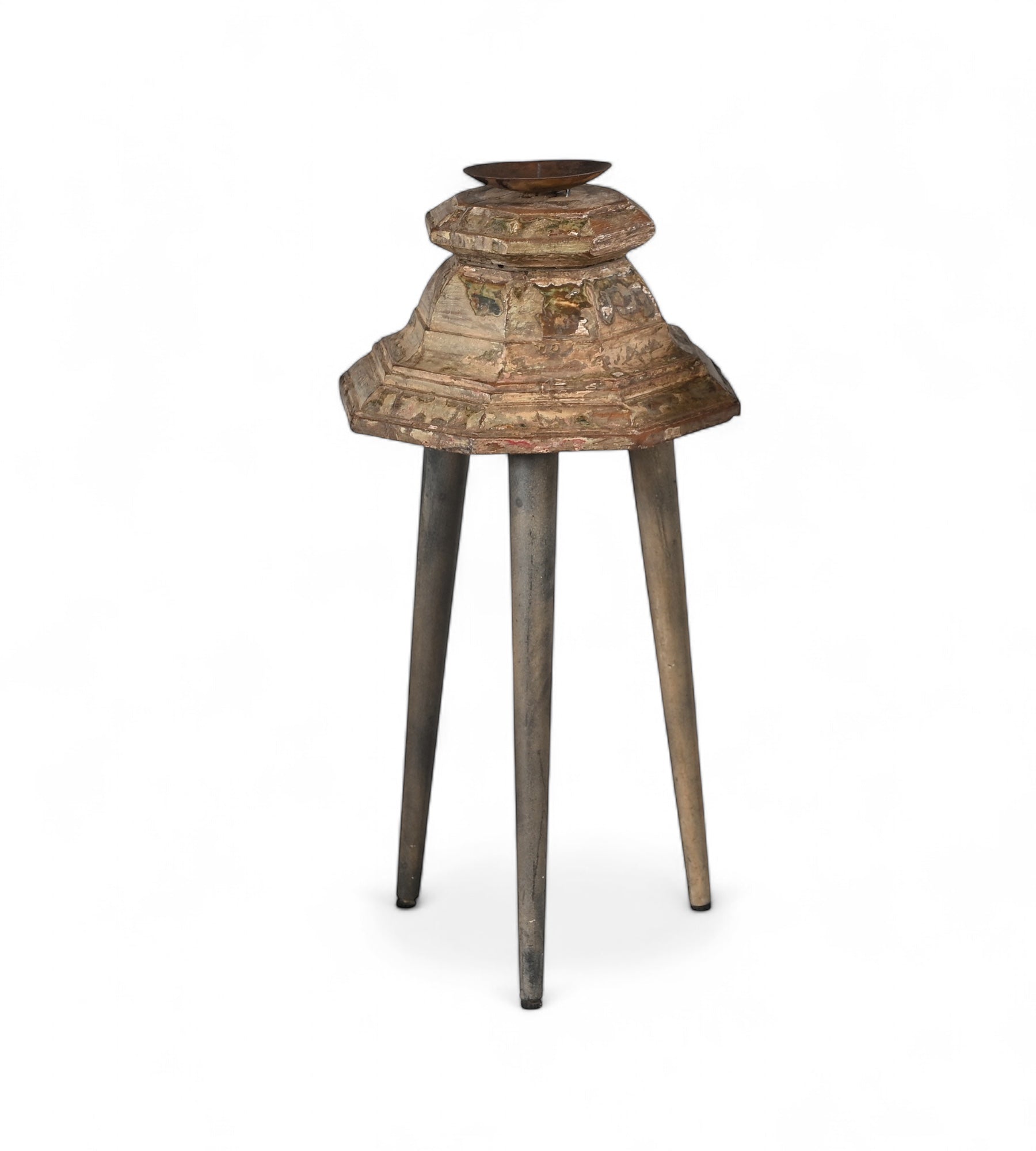 Carved teak candle holders on top of three legs