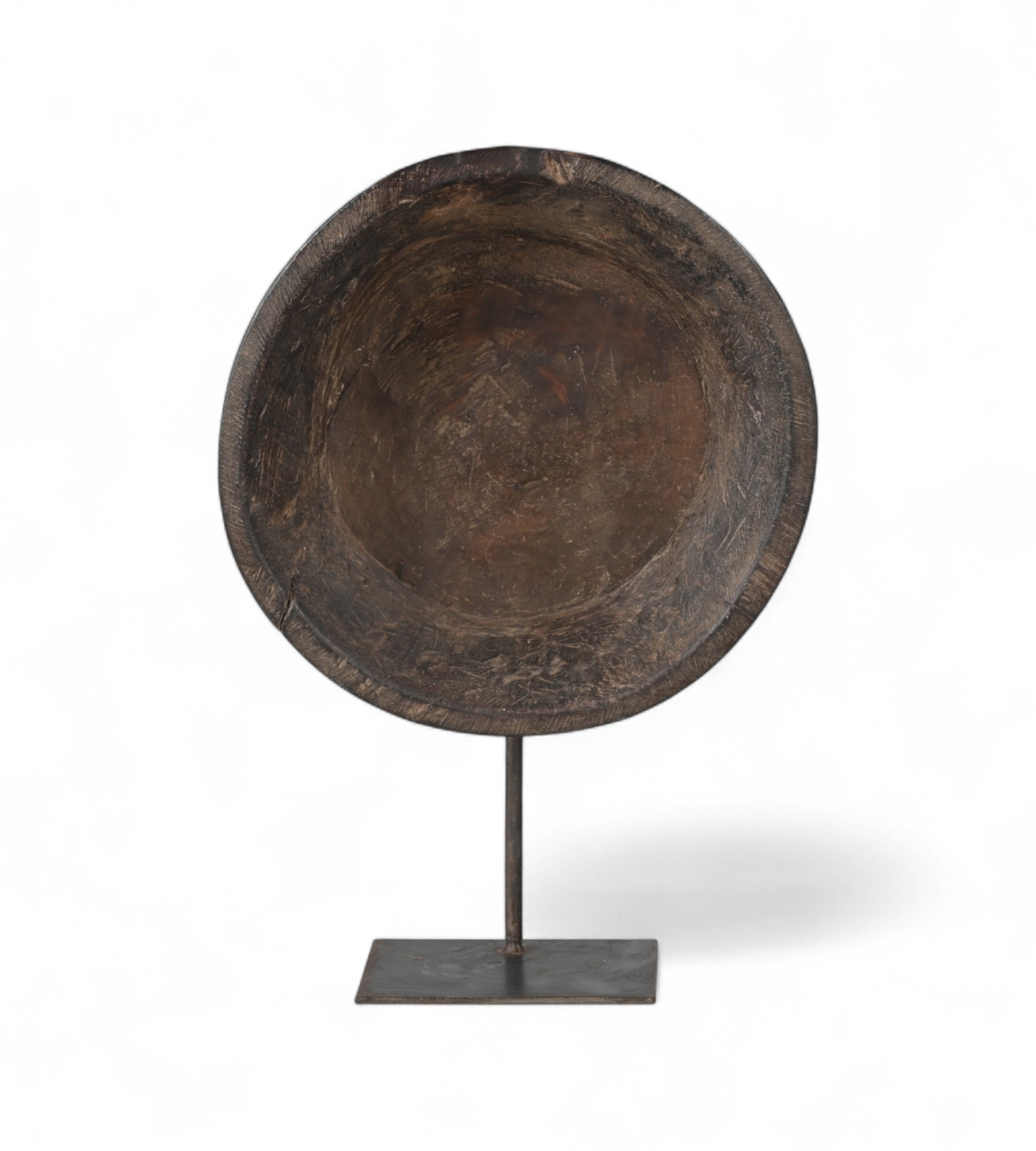 A wooden parat (bowl) with visible patina and textures, placed on an iron stand.