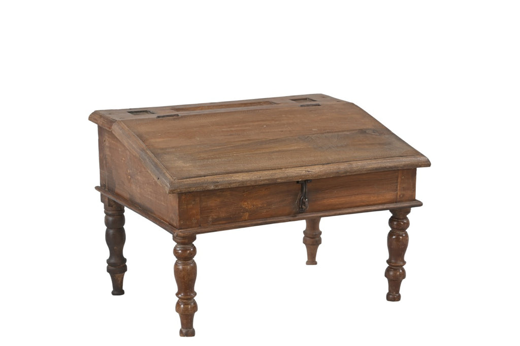 A vintage teak wood desk with a visible wood grain pattern and carved legs, with a closed hinged lid.