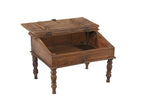 A vintage teak wood desk with a visible wood grain pattern and carved legs, with a closed hinged lid.