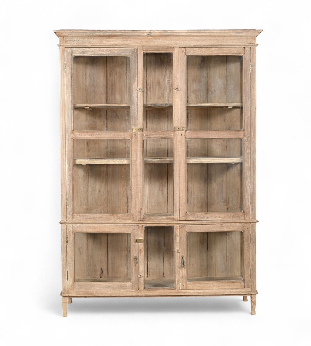 A vintage teak wood glass display cabinet with panelled doors and a sun hand wash finish.