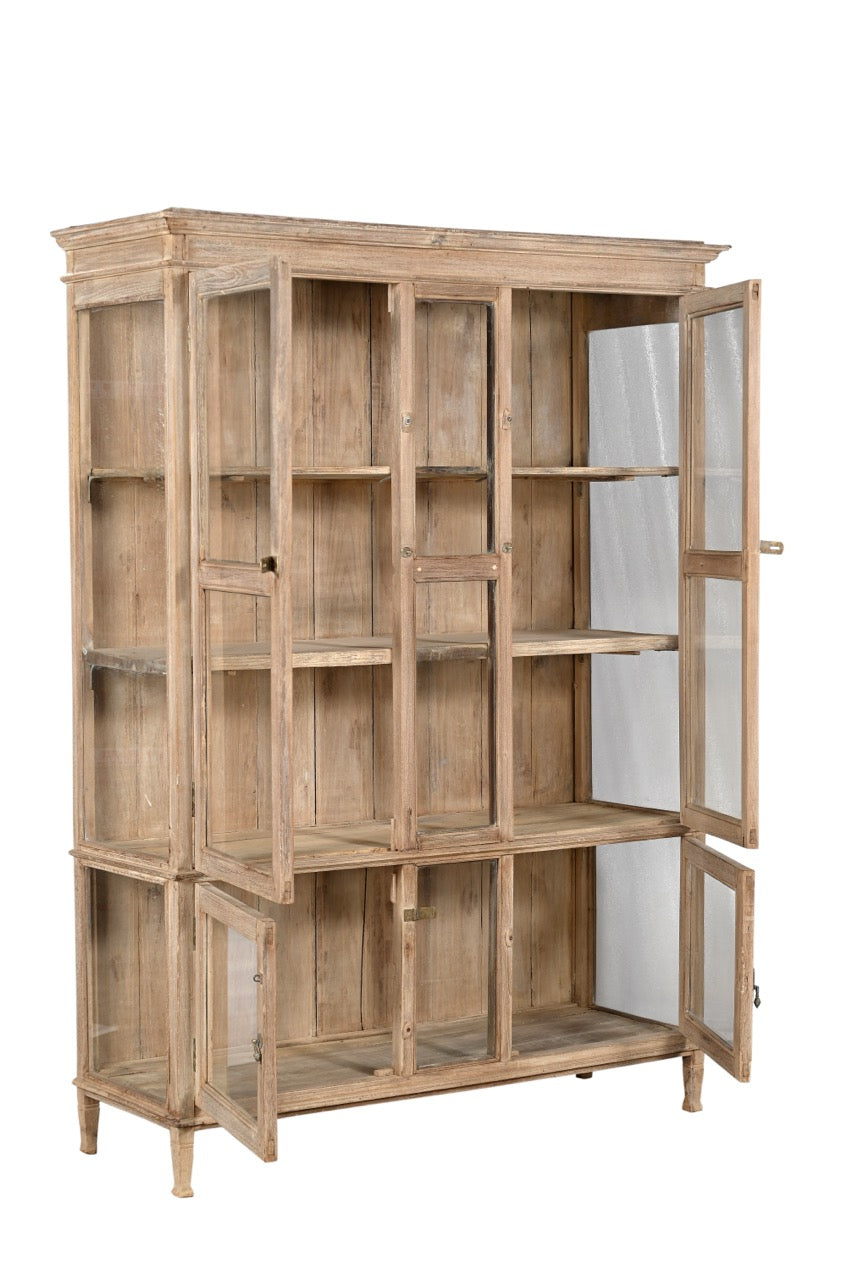 A vintage teak wood glass display cabinet with panelled doors and a sun hand wash finish.