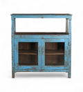 A vintage teak wood and glass cabinet with blue paint and patina, featuring a top shelf and double doors.