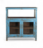 A vintage teak wood and glass cabinet with blue paint and patina, featuring a top shelf and double doors.