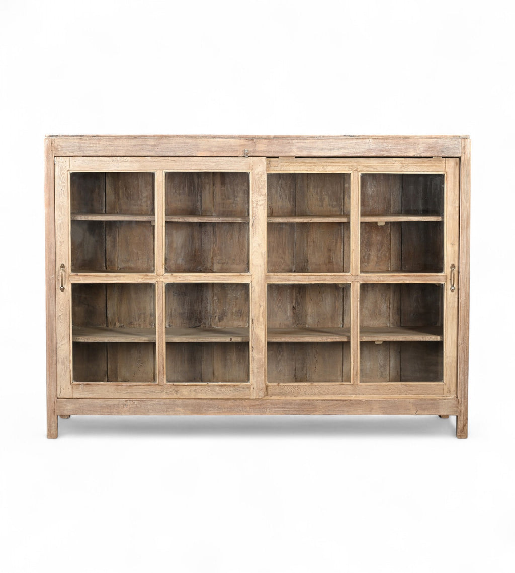 A vintage teak wood glass display cabinet with two doors and a flat top, featuring a warm brown finish.