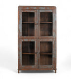 A vintage teak wood glass display cabinet with four glass doors and a visible wood patina of earthy brown and faded indigo.