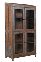 A vintage teak wood glass display cabinet with four glass doors and a visible wood patina of earthy brown and faded indigo.