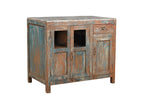 A vintage teak wood cabinet with glass panels on the doors and a painted terracotta red, deep blue, and neutral colours finish.