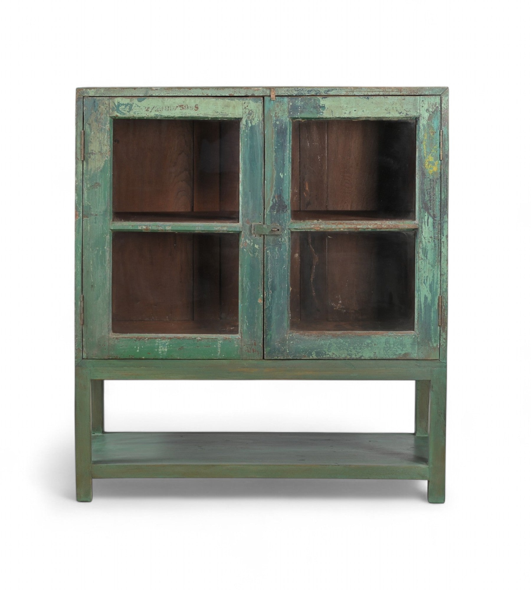 A vintage teak wood glass display cabinet with green paint on the exterior and brown interior, featuring two glass panelled doors with a single shelf.