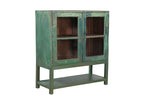 A vintage teak wood glass display cabinet with green paint on the exterior and brown interior, featuring two glass panelled doors with a single shelf.