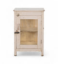 A vintage teak wood side cabinet in a white finish with a glass panel on the door, and one internal shelf.