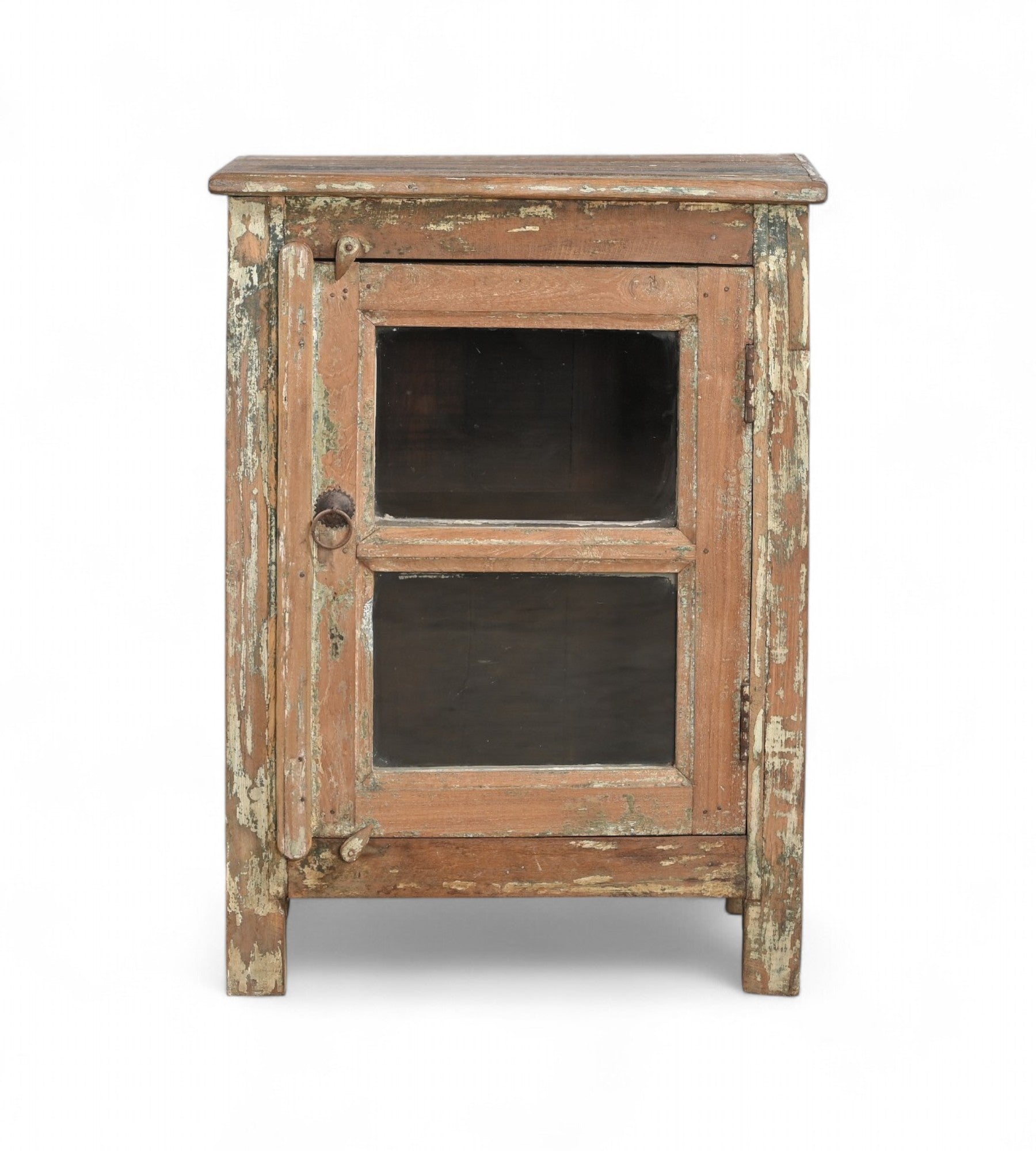 A vintage teak wood side cabinet with a weathered frame, a glass door, and a metal pull ring