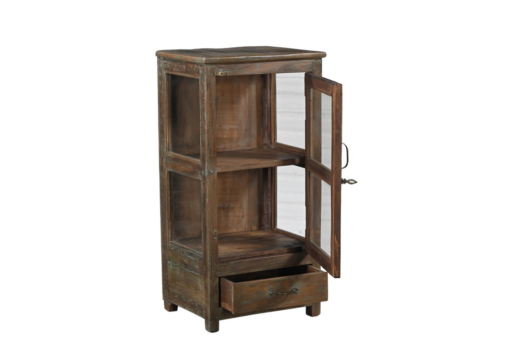 A vintage teak wood side cabinet with a glass display door and a drawer, showing a brown and green patina.