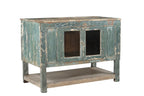 A vintage teak wood sideboard cabinet with glass double front doors and a distressed sea green finish