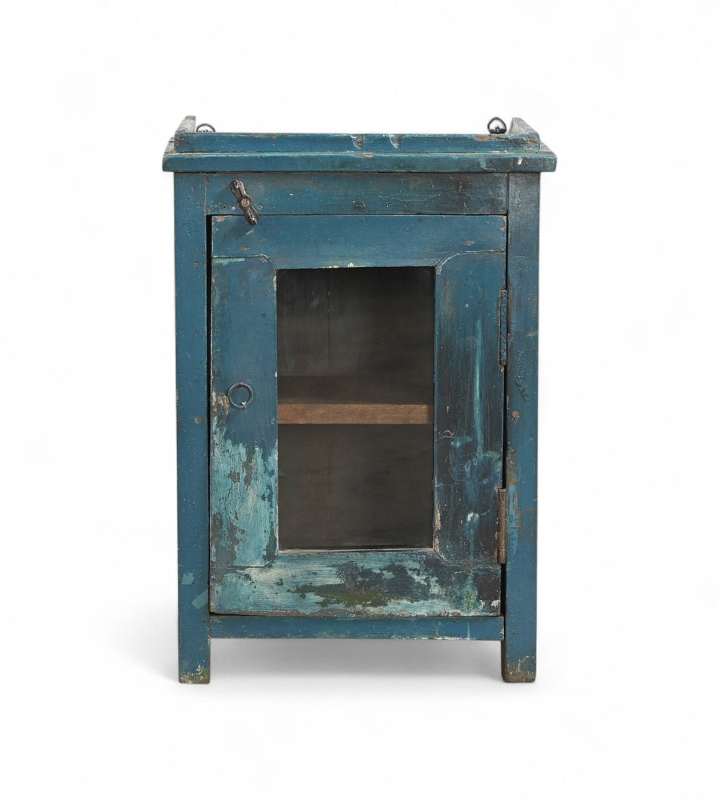 A vintage teak wood side cabinet with a blue painted exterior, iron hardware, and a glass front door.