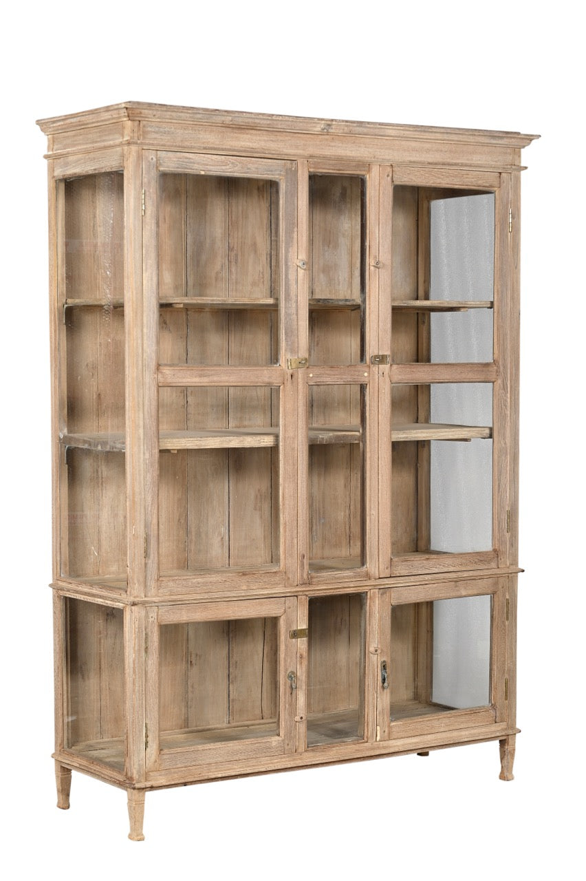 A vintage teak wood glass display cabinet with panelled doors and a sun hand wash finish.
