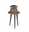 Carved teak candle holders on top of three legs