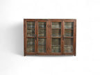 A vintage teak and recycled wood glass cabinet with a teal-grey finish on the back and sides.