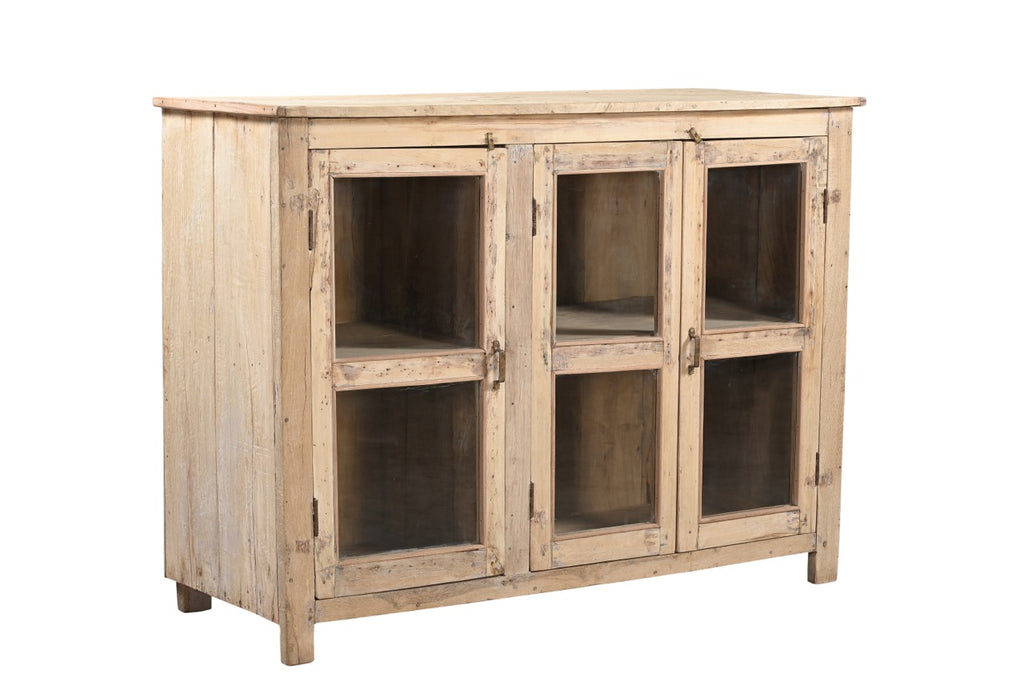 A vintage teak and recycled wood glass cabinet with a warm honey tone finish and three glass doors.