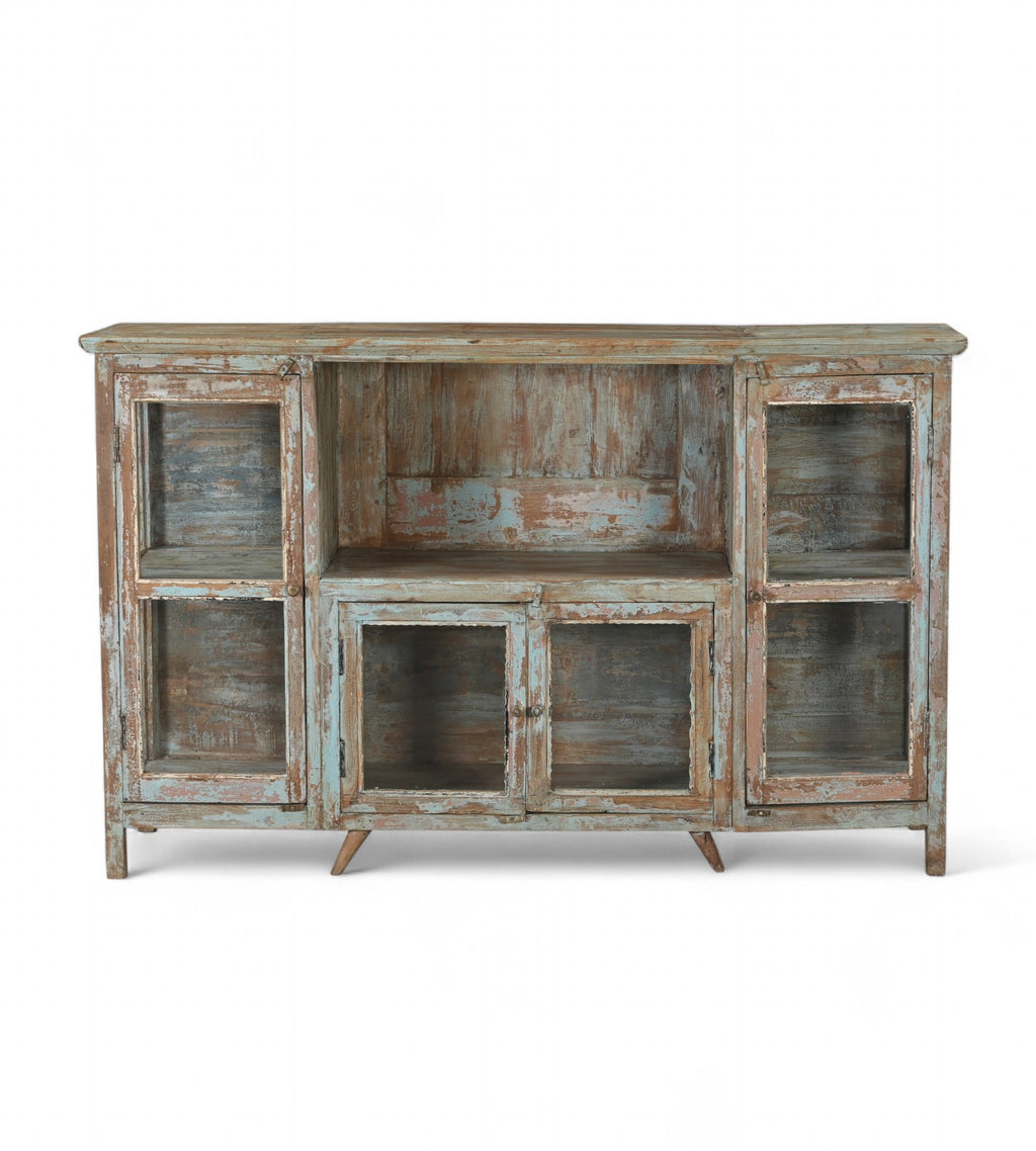 A vintage teak wood sideboard with glass doors and a distressed hand wash finish in earthy tones.