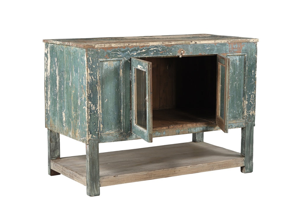 A vintage teak wood sideboard cabinet with glass double front doors and a distressed sea green finish