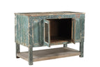 A vintage teak wood sideboard cabinet with glass double front doors and a distressed sea green finish