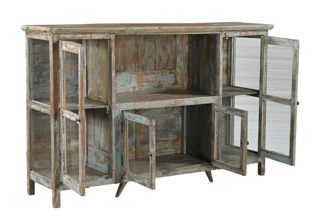 A vintage teak wood sideboard with glass doors and a distressed hand wash finish in earthy tones.