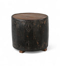A cylindrical vintage side table made of iron with a teak wood top, featuring ring handles and a worn black finish.